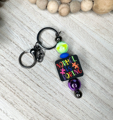 Normal is boring keychain